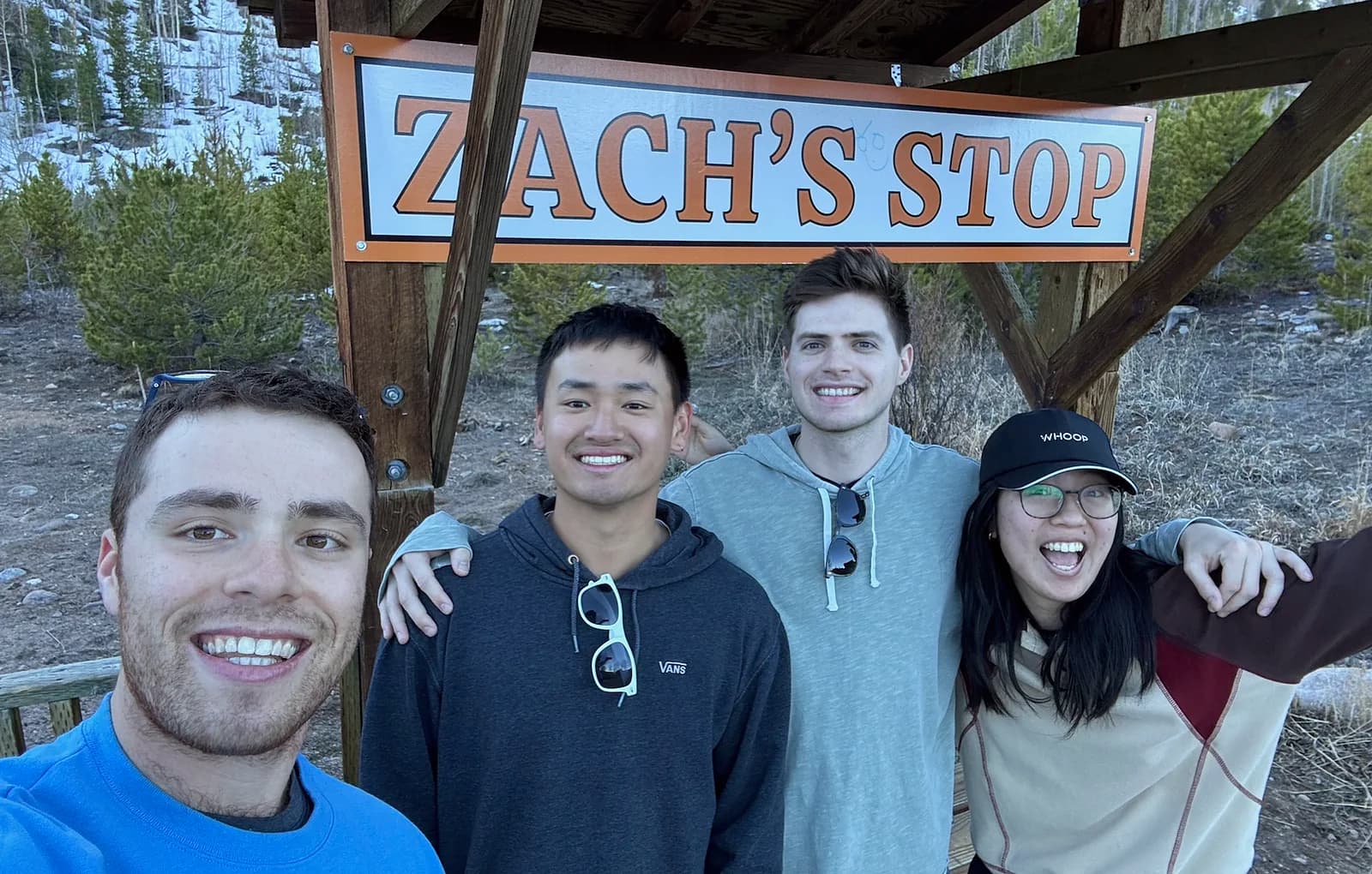 The four of us under the Zach's Stop sign in the mountains