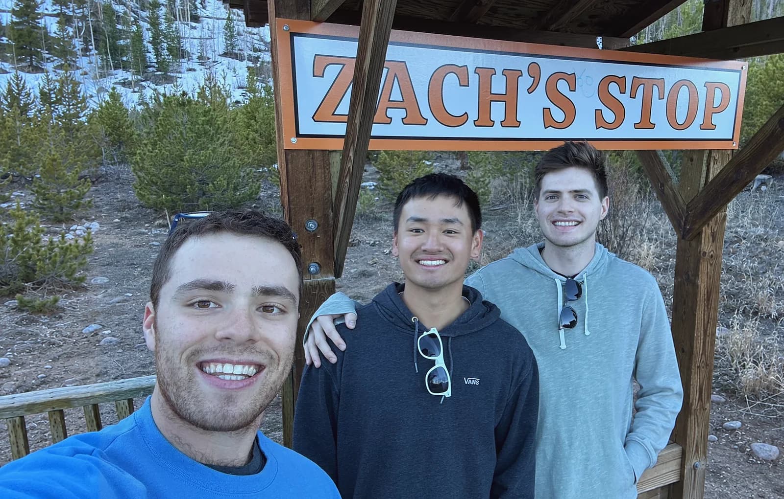 The three of us under the Zach's Stop sign in the mountains